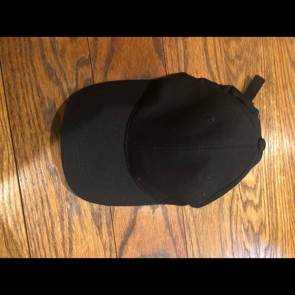 black cap with “you go girl” detailing on the back